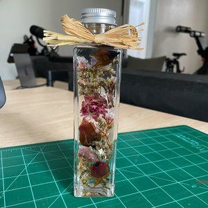 Preserved Flowers encased in a Glass Bottle